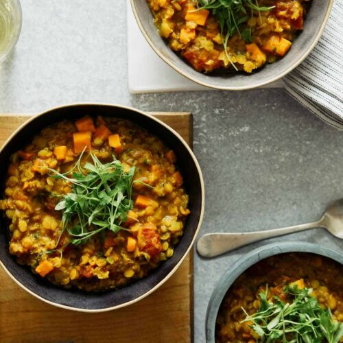 Several bowls of masoor dal. with spoons.