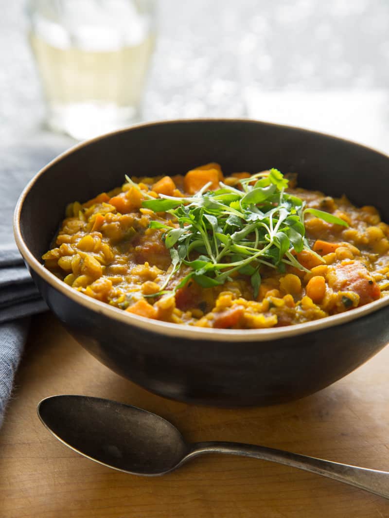 Dal recipe in a bowl with a spoon next to it.