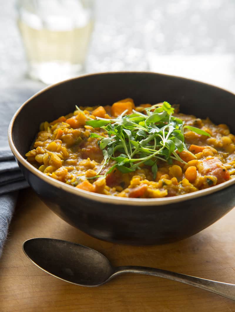 Dal recipe in a bowl with a spoon next to it. 