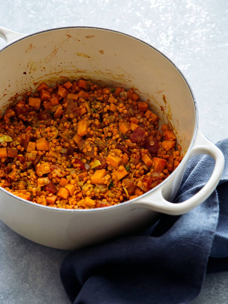 Stewed red lentils in a pot after being cooked. 