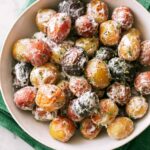 Creamy Roasted Potato Salad in a bowl on top of a green napkin.