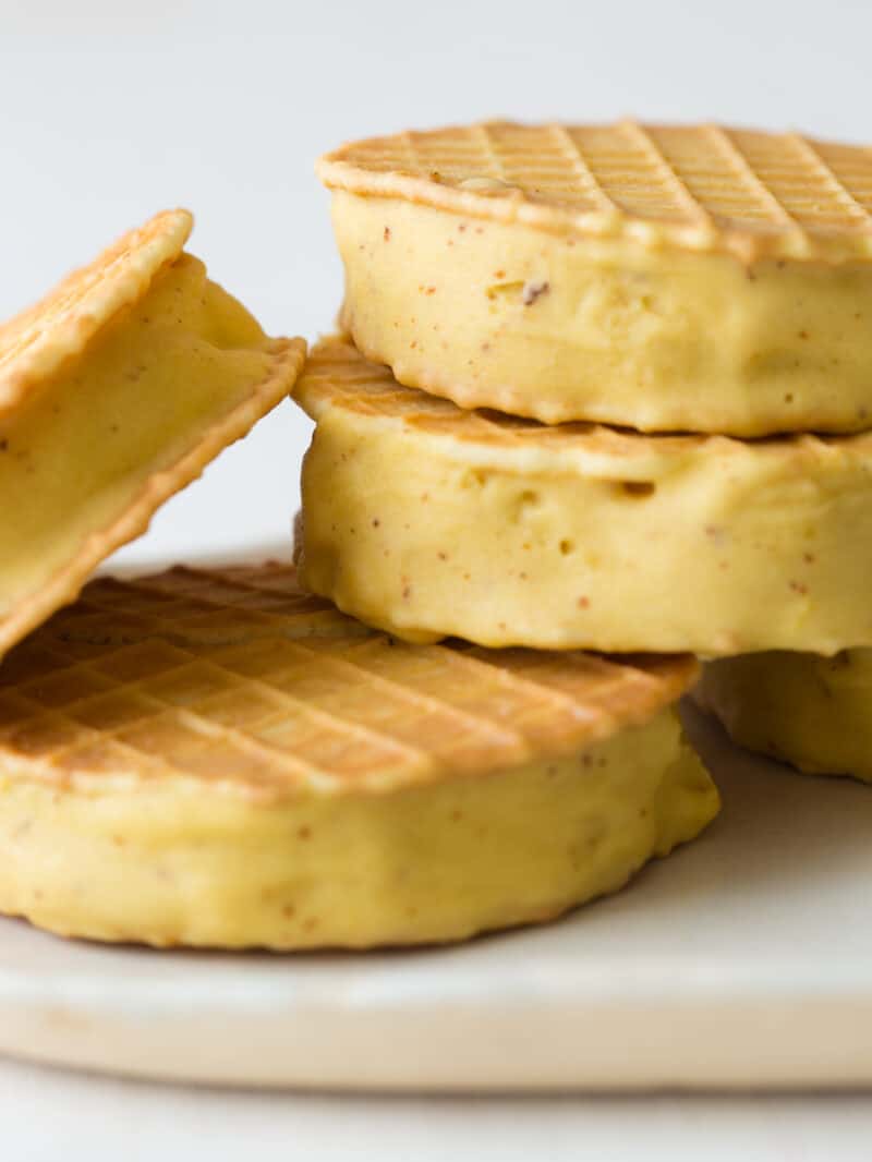 A close up of a pile of brown butter ice cream sandwiches.