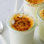 A close up of small jars of crème brûlée  frozen custard ice cream.