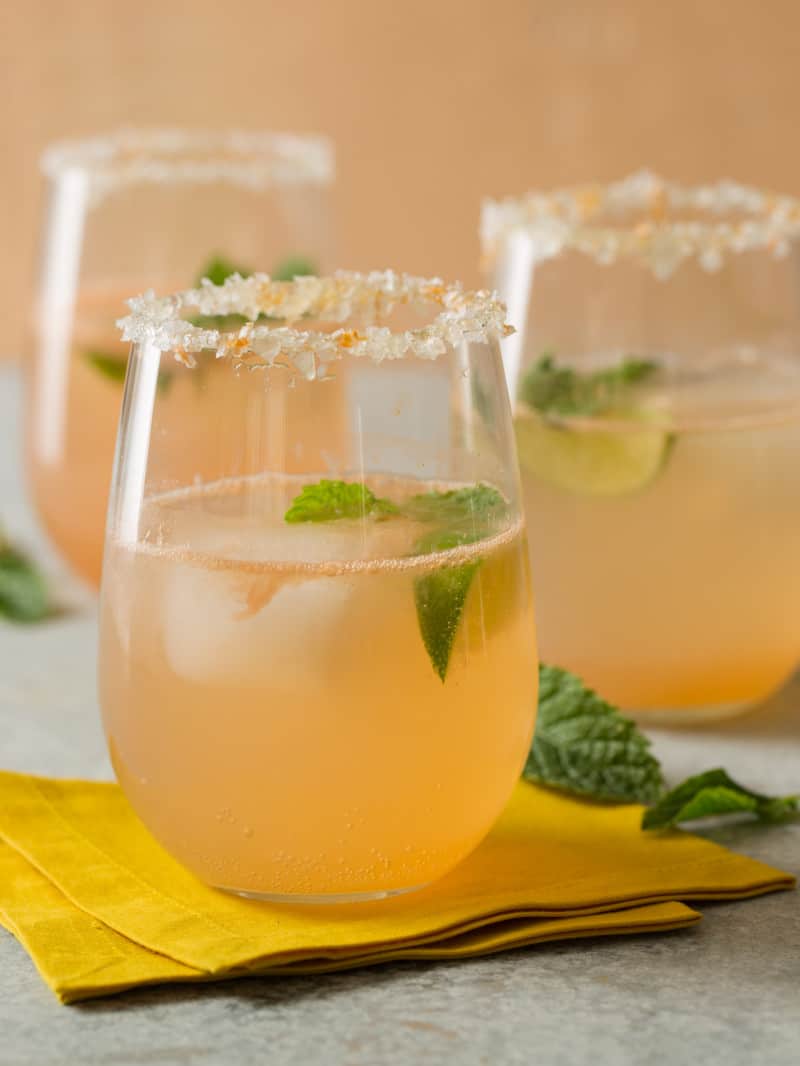 Paloma cocktail with mint leaves and sugared rim. 