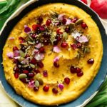 A close up on a roasted pumpkin hummus in a bowl.