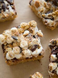 Close up on a slice of S'mores Rice Krispies treats on a piece of parchment.