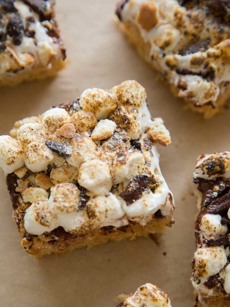 Close up on a slice of S'mores Rice Krispies treats on a piece of parchment. 