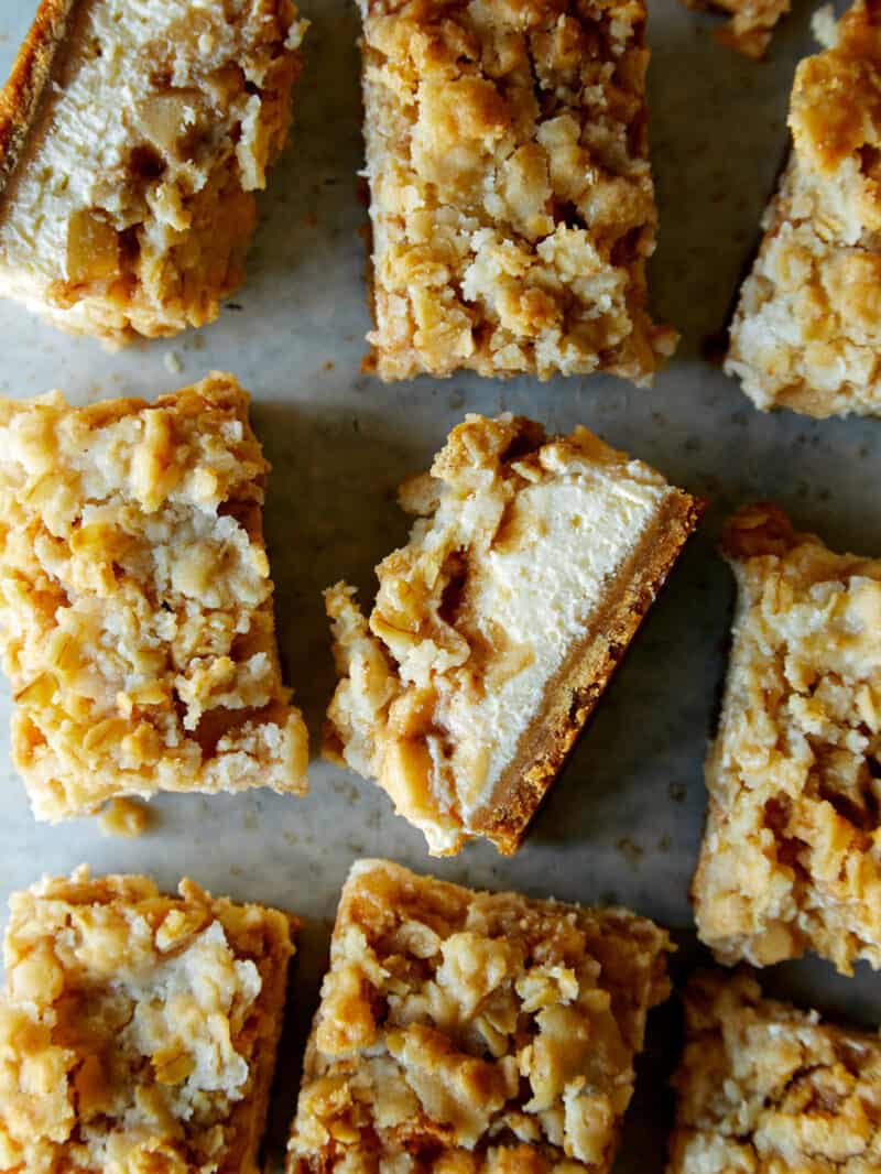 A close up of streusel topped apple pie cheesecake bars.