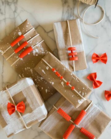 A variety of boxes wrapped in DIY pasta gift wrap.