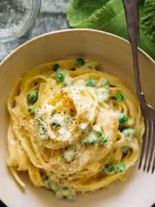 A close up of browned butter fettuccine alfredo with a fork.