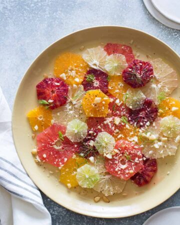 Citrus and fennel salad on a cream colored plate.