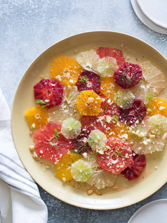 Citrus and fennel salad on a cream colored plate.