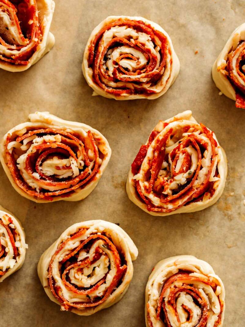 A close up of uncooked pizza wheels.