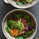 Korean spicy sashimi salad in gray bowls.