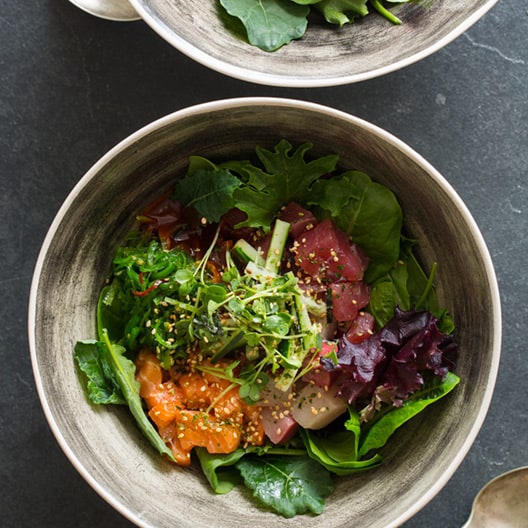 Spicy sashimi salad in two bowls. 