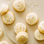 Soft and fluffy sugar cookies with vanilla frosting and sprinkles.