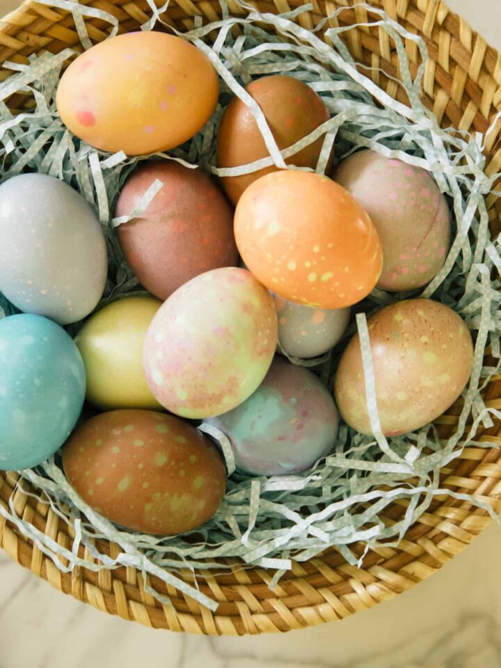 A close up of spotted Easter eggs in a basket.