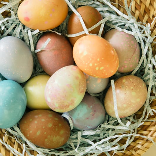 Spotted dyed easter eggs in a basket. 