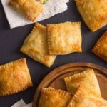 A close up of a plate of chicken pot pie hand pies.