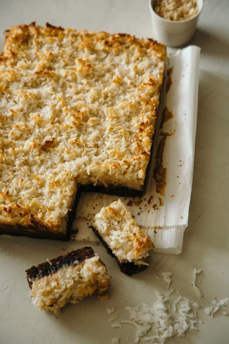 Coconut and peanut butter brownie bars being sliced off a corner.