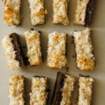 Coconut and peanut butter brownie bars sliced and lined up.