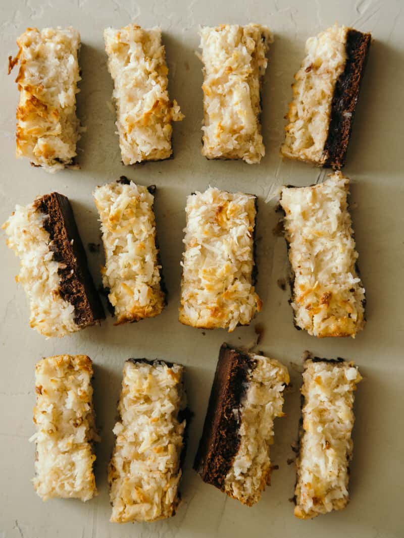 Coconut and peanut butter brownie bars sliced and lined up.