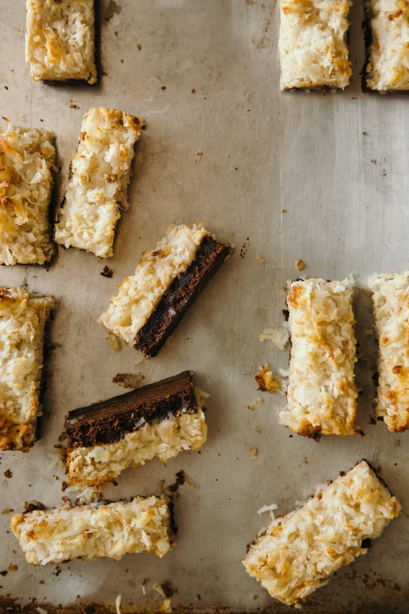 Coconut and peanut butter brownie bars sliced and scattered.