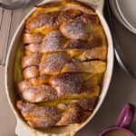 Stacked and stuffed baked French toast in an oval baking dish.