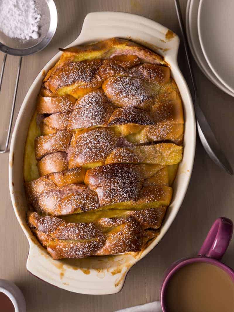Stacked and stuffed baked French toast in an oval baking dish.