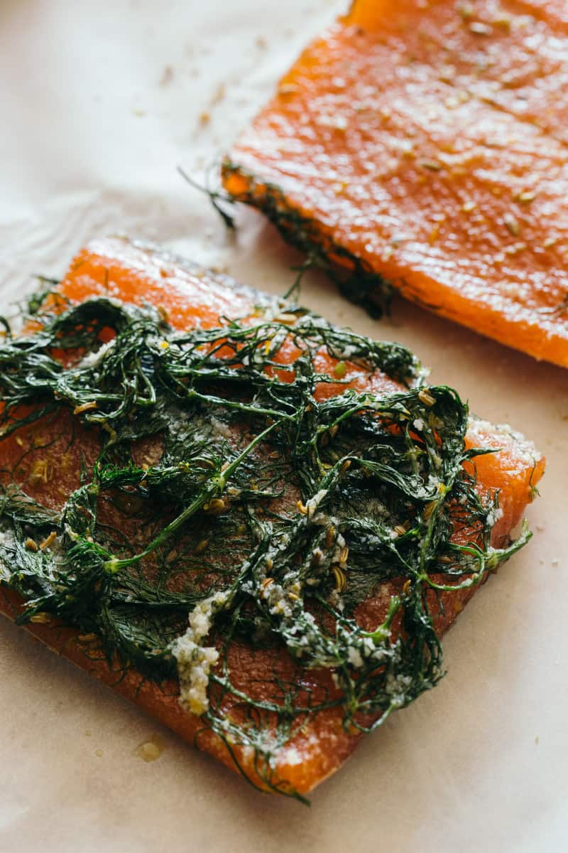 A close up of salmon with dill and dill on top.