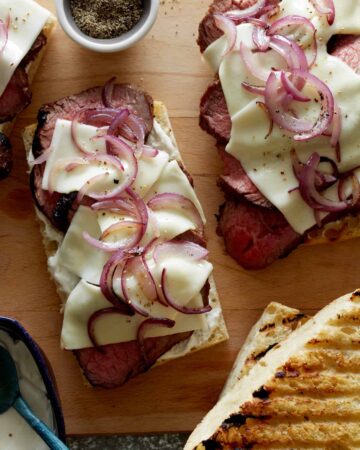Grilled open face sandwich with tri-tip, cheese and onion.