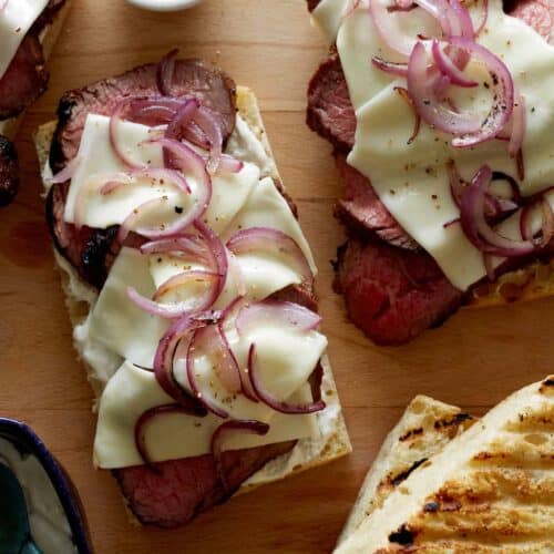 Grilled open face sandwich with tri-tip, cheese and onion.