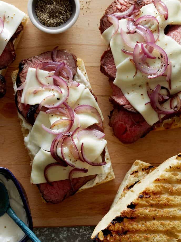 Grilled open face sandwich with tri-tip, cheese and onion.