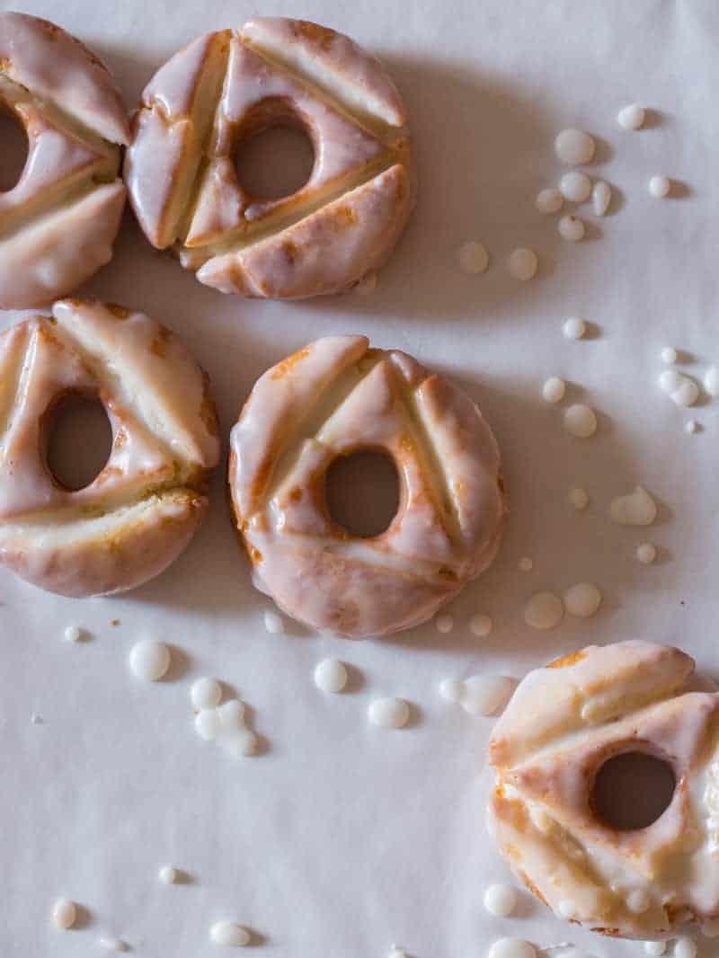 A close up of homemade glazed old fashioned doughnuts.