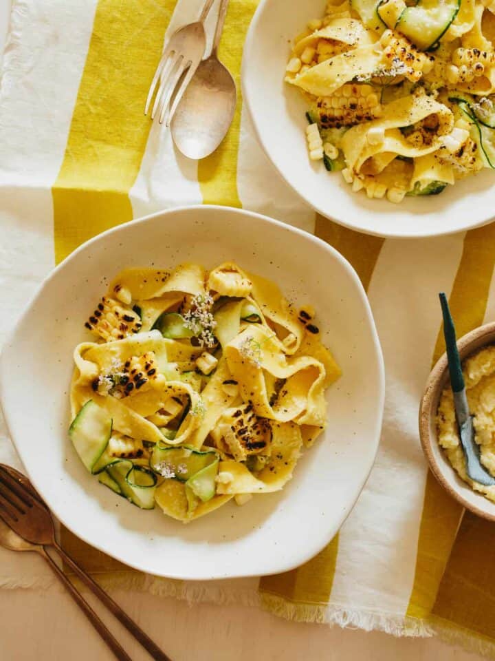 Bowls of sweet corn pesto with pappardelle and zucchini noodles.
