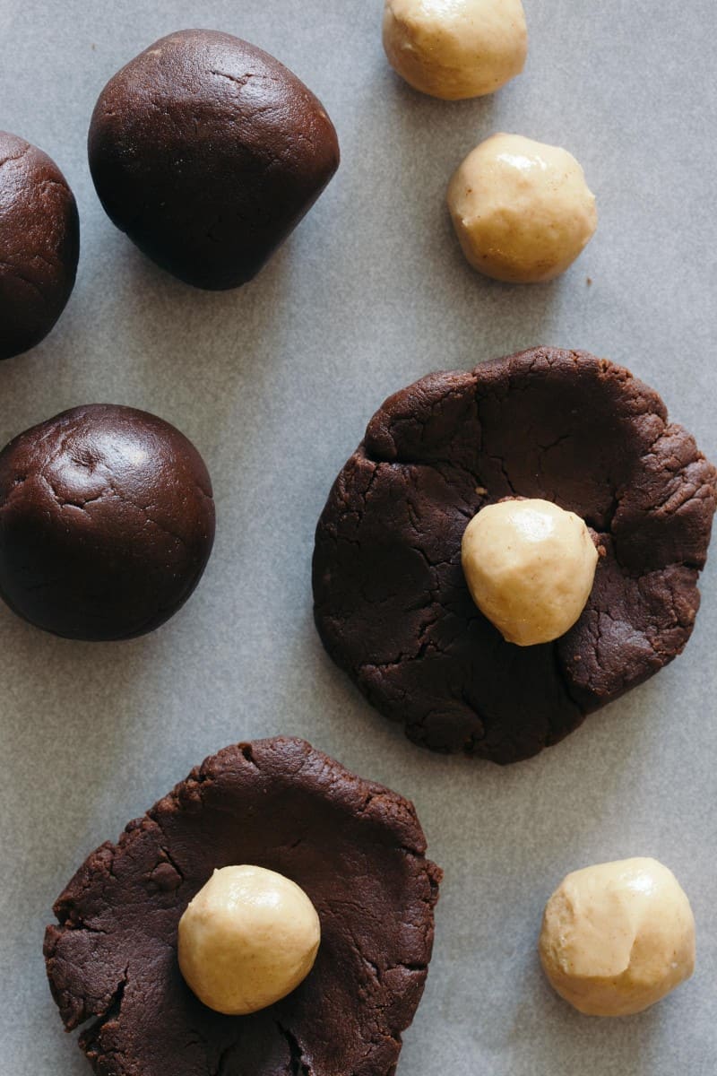 Raw chocolate cookie dough rolled out with peanut butter stuffing.