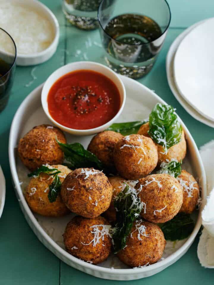 Mozzarella stuffed chicken parmesan meatballs with marinara sauce on the side.