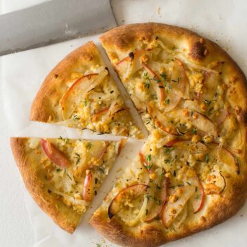 A sliced caramelized onion, apple, and bleu cheese pizza.