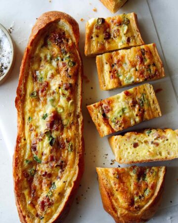 Baked egg boats with a knife.