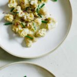 Plates of caramelized apple and herb fiocchi with gorgonzola cream sauce.