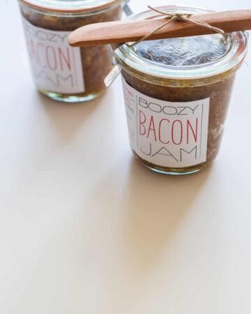 Jars of bacon jam with printed labels attached.