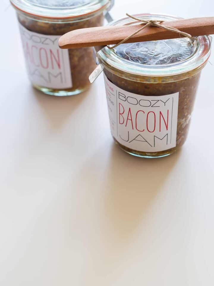 Jars of bacon jam with printed labels attached.