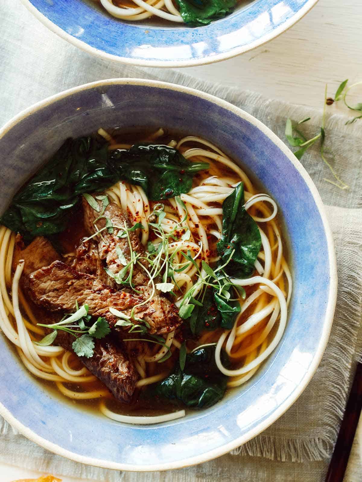 Beef noodle soup in two bowls. 