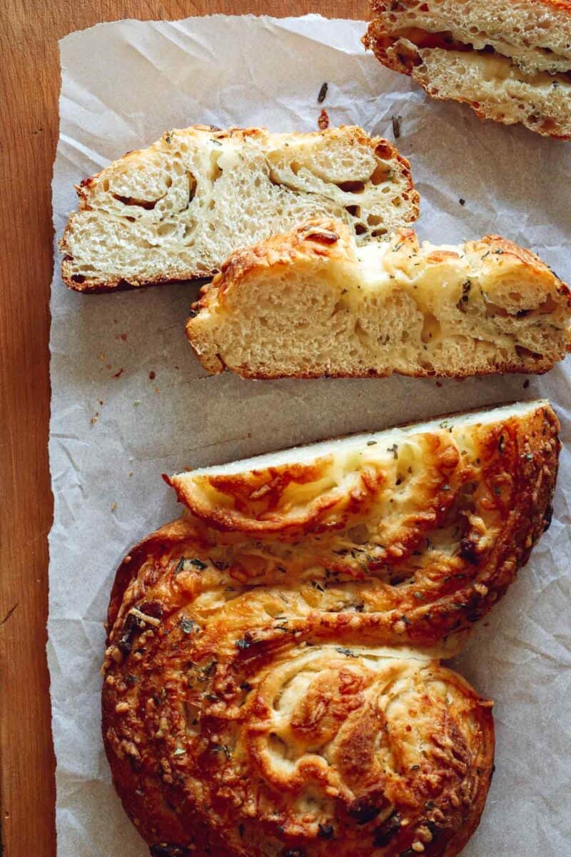 Sliced cheesy roasted garlic and herb pane bianco.