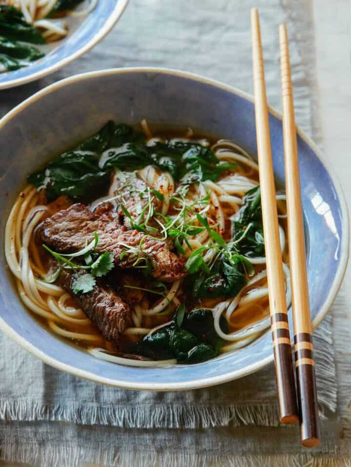 Garlic Ginger Beef Noodle Soup Spoon Fork Bacon