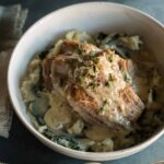 Milk braised pork shoulder over browned butter colcannon in a bowl.