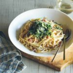 A bowl of creamy garlic pancetta spaghetti with crispy shredded brussels sprouts.