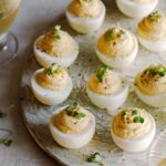 Caramelized onion and herb deviled eggs on a platter.