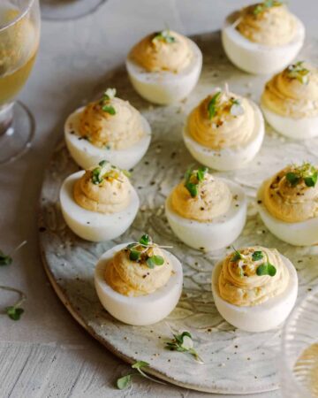 Caramelized onion and herb deviled eggs on a platter.