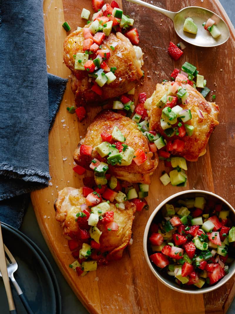 Baked chicken thighs with a strawberry avocado salsa on top.